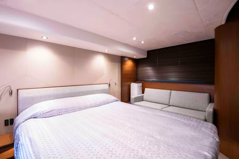  Yacht Photos Pics Luxurious bedroom interior of 2017 Princess 52 yacht with modern decor and cozy lighting.