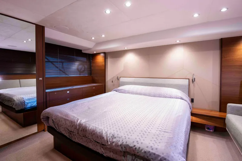  Yacht Photos Pics Luxurious bedroom interior of 2017 Princess 52 yacht with modern design and ambient lighting.