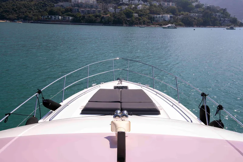  Yacht Photos Pics Bow view of 2017 Princess 52 yacht on serene water with scenic backdrop.