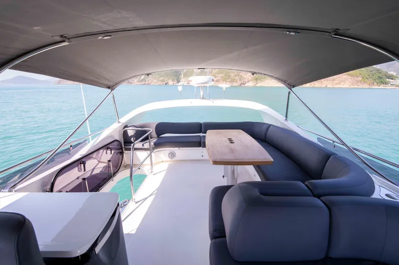  Yacht Photos Pics Luxurious 2017 Princess 52 yacht deck with seating and table, overlooking serene waters.