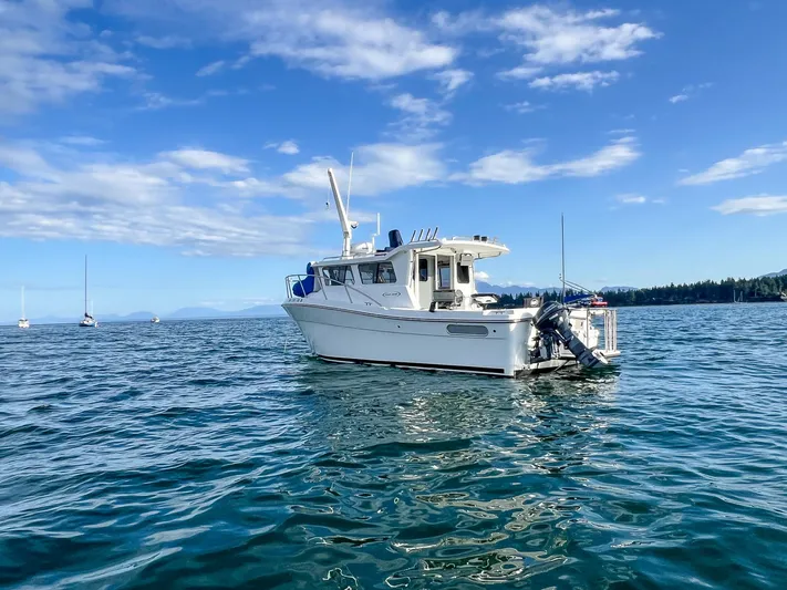  Yacht Photos Pics 2021 Ocean Sport 26/27 boat on calm water under blue sky.