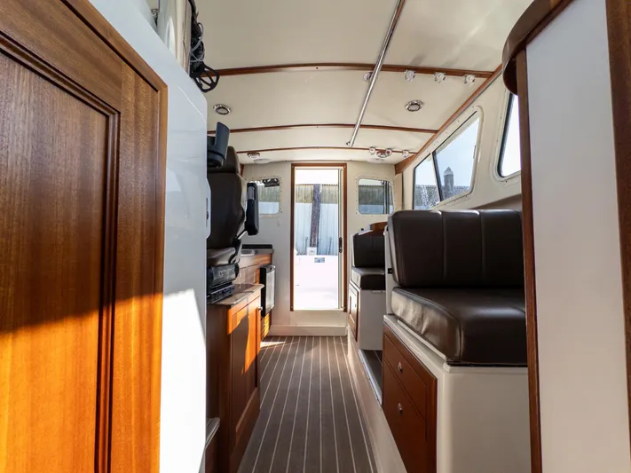  Yacht Photos Pics Interior of 2021 Ocean Sport 26/27 boat with wood accents and seating.