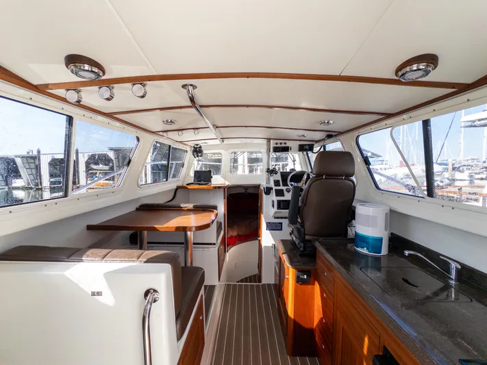  Yacht Photos Pics Interior of 2021 Ocean Sport 26/27 boat with seating, helm, and kitchenette.