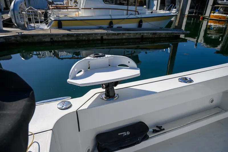  Yacht Photos Pics 2021 Ocean Sport 26/27 boat detail at marina, featuring a mounted accessory holder.