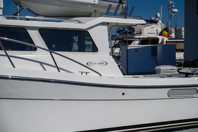  Yacht Photos Pics 2021 Ocean Sport 26/27 boat docked at marina, side view.