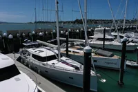 Sailboats docked at marina, featuring a 2011 Moody DS 45 under clear blue skies.