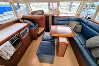 Luxurious interior of 2011 Moody DS 45 yacht with blue seating and wooden accents.