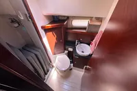Compact bathroom in 2011 Moody DS 45 yacht with toilet, sink, and storage.