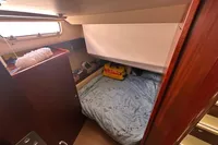 Cozy cabin interior of 2011 Moody DS 45 yacht with bed and window.