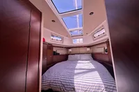 Luxurious cabin interior of 2011 Moody DS 45 yacht with skylights and striped bedding.
