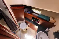 Luxurious bathroom in 2011 Moody DS 45 yacht with modern fixtures and wooden cabinetry.