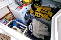 Storage compartment in a 2011 Moody DS 45 yacht with washing machine and safety gear.