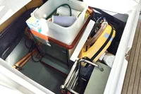 Storage compartment on a 2011 Moody DS 45 yacht, containing various boating equipment and supplies.