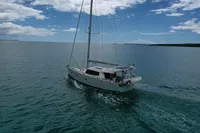 Sailing yacht Moody DS 45, 2011 model, cruising on calm ocean waters under a partly cloudy sky.