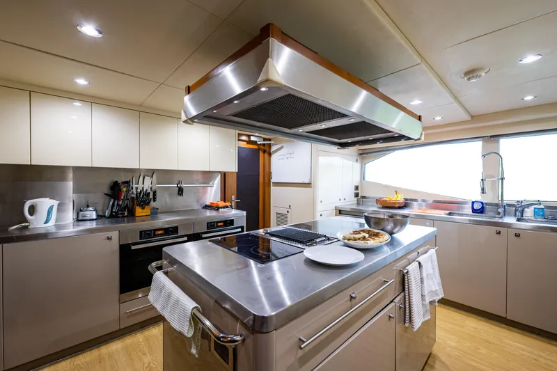 About Time Yacht Photos Pics Luxurious kitchen interior on 2010 Sunseeker 40 Metre Yacht, featuring modern appliances and sleek design.