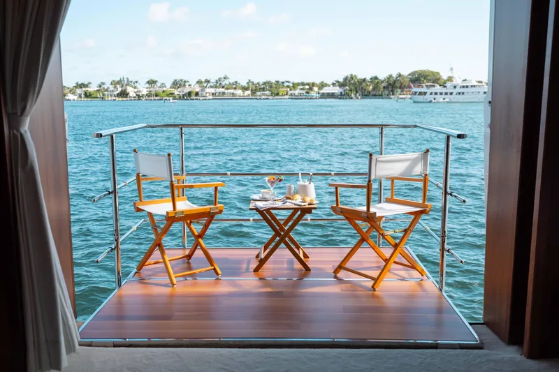 About Time Yacht Photos Pics Sunny yacht deck with chairs and table overlooking serene water, Sunseeker 40 Metre Yacht 2010.