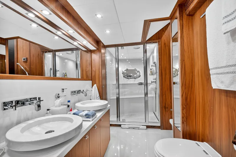 About Time Yacht Photos Pics Luxurious bathroom on 2010 Sunseeker 40 Metre Yacht with wood accents and modern fixtures.