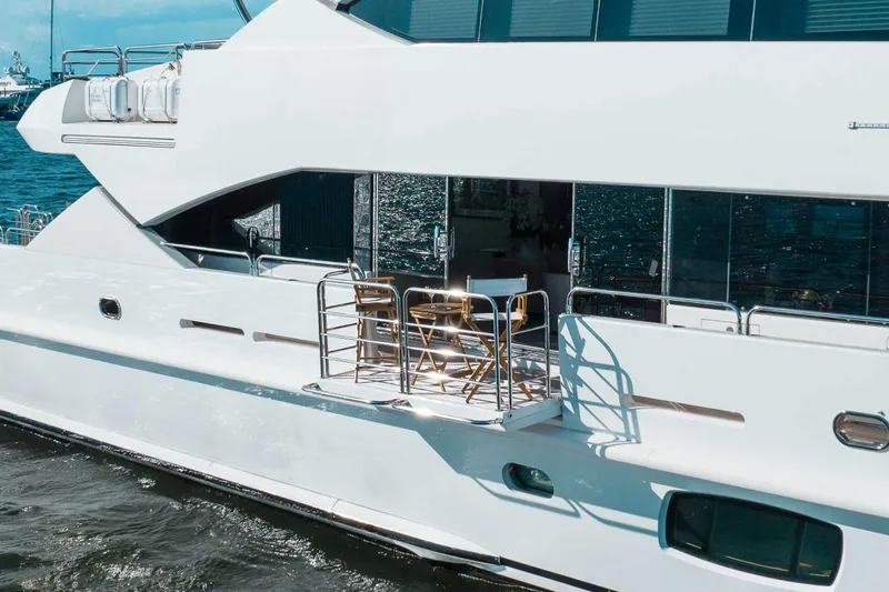 About Time Yacht Photos Pics Sunseeker 40 Metre Yacht 2010, elegant deck view with chairs, on calm water.