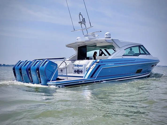  Yacht Photos Pics 2023 Formula 500 Super Sport Crossover boat cruising on water with multiple outboard engines.