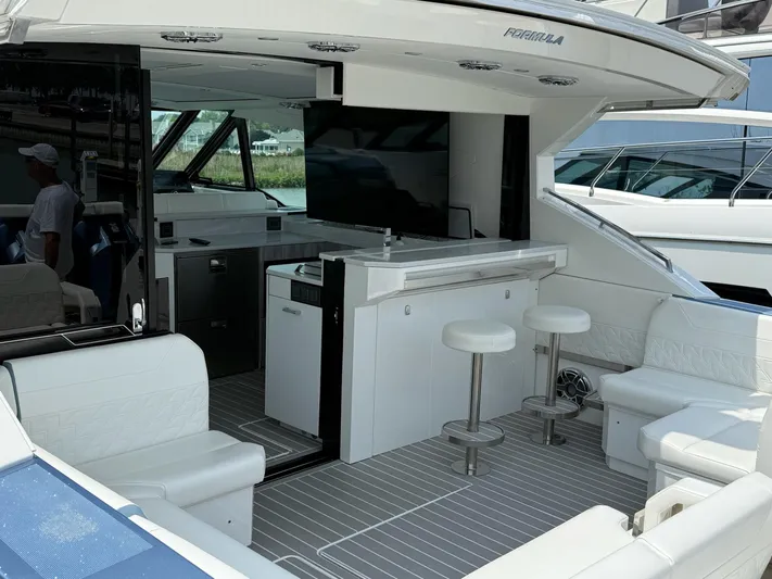  Yacht Photos Pics 2023 Formula 500 Super Sport Crossover yacht interior with seating and bar area.