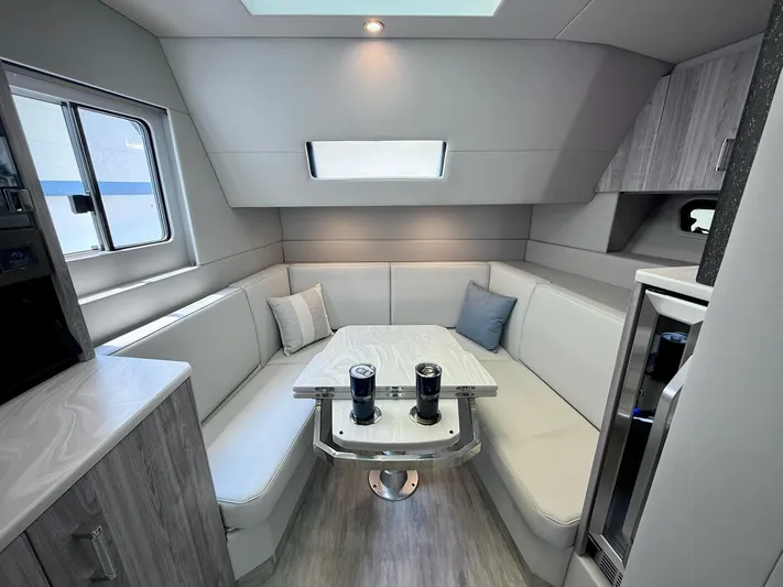  Yacht Photos Pics Luxurious interior of 2023 Formula 500 Super Sport Crossover with modern seating and table.