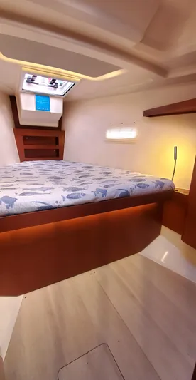 Hanse 388 #396 Yacht Photos Pics 2024 Hanse 388 yacht cabin with cozy bed and modern lighting.