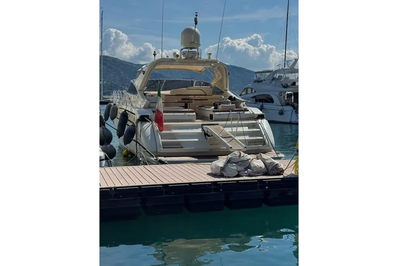  Yacht Photos Pics Luxury Riva 59 Mercurius yacht docked at marina, 2002 model, with scenic mountain backdrop.