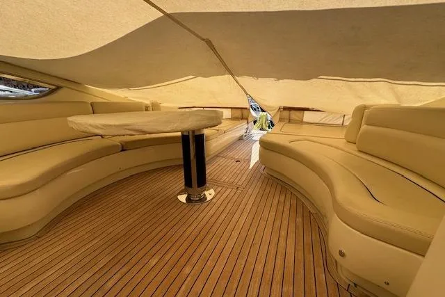  Yacht Photos Pics Luxurious interior of 2002 Riva 59 Mercurius yacht with elegant seating and wooden flooring.