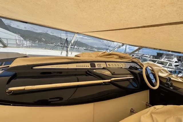  Yacht Photos Pics 2002 Riva 59 Mercurius yacht helm with covered dashboard and steering wheel.