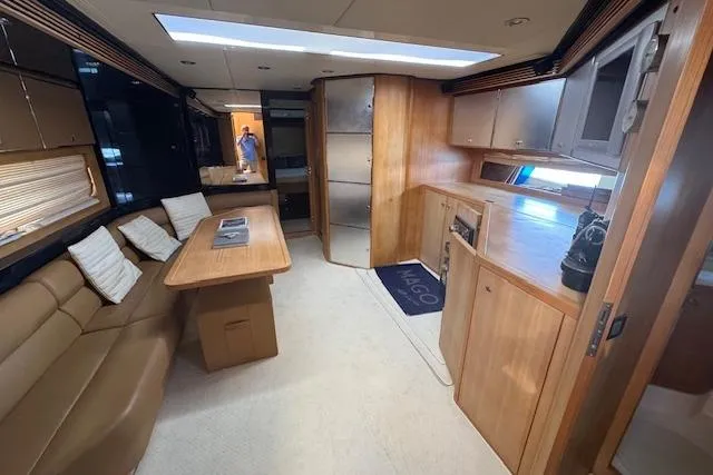  Yacht Photos Pics Luxurious interior of a 2002 Riva 59 Mercurius yacht with elegant wood finishes.