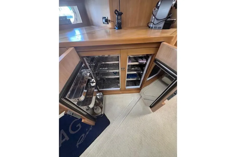  Yacht Photos Pics Interior of 2002 Riva 59 Mercurius yacht with open cabinets and appliances.