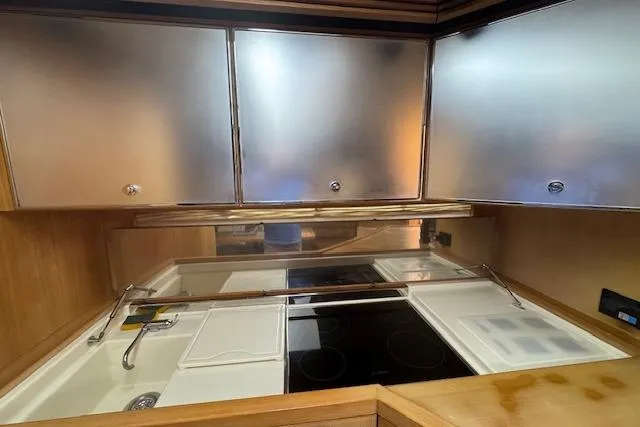  Yacht Photos Pics Modern kitchen area in a 2002 Riva 59 Mercurius yacht with sleek cabinetry.