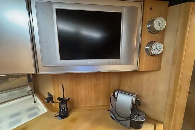  Yacht Photos Pics Interior of 2002 Riva 59 Mercurius yacht with TV, radio, and coffee machine.