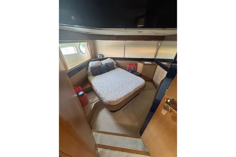  Yacht Photos Pics Luxurious cabin interior of 2002 Riva 59 Mercurius yacht with cozy bed and porthole.