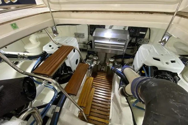 Whole Life Yacht Photos Pics Engine room of 2011 Grand Banks 46 Eastbay SX with dual engines and wooden steps.