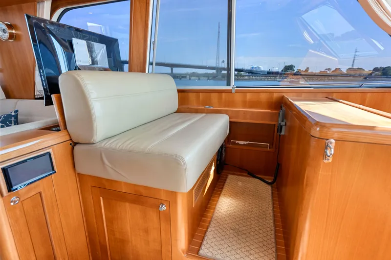 Whole Life Yacht Photos Pics Interior of 2011 Grand Banks 46 Eastbay SX yacht with beige seating and wooden finishes.