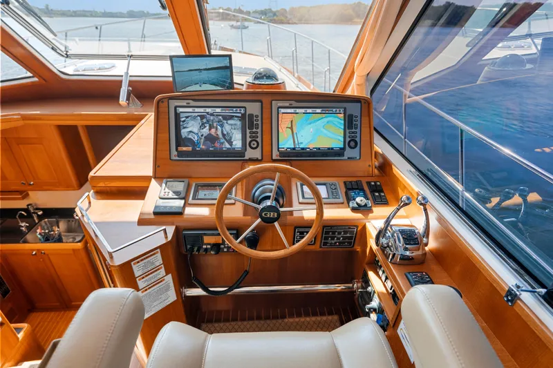 Whole Life Yacht Photos Pics Helm of 2011 Grand Banks 46 Eastbay SX yacht with navigation screens and controls.
