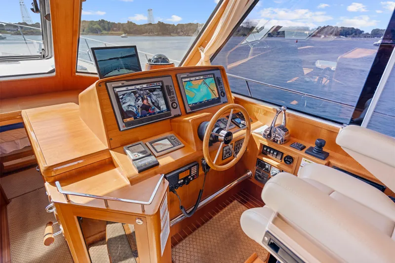 Whole Life Yacht Photos Pics Helm of 2011 Grand Banks 46 Eastbay SX with navigation screens and steering wheel.