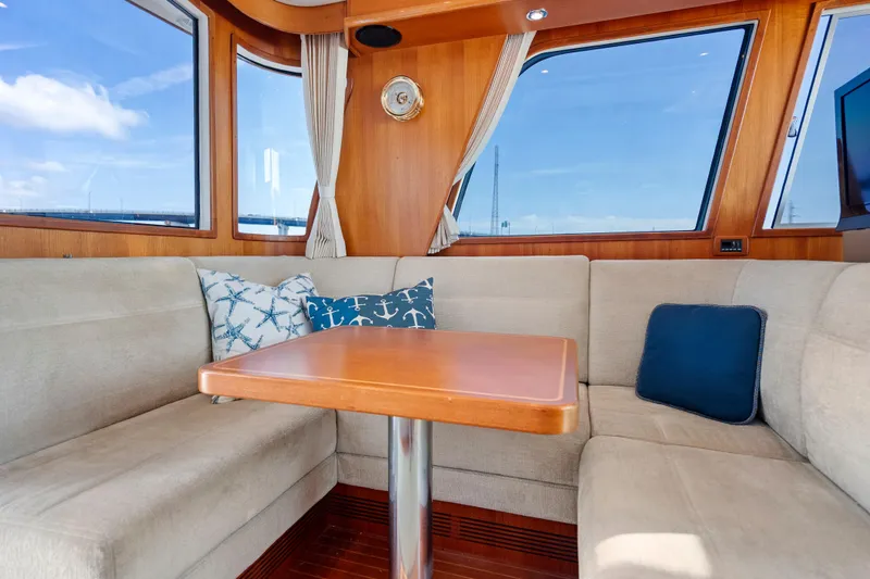 Whole Life Yacht Photos Pics Luxurious interior of 2011 Grand Banks 46 Eastbay SX yacht with plush seating and nautical decor.