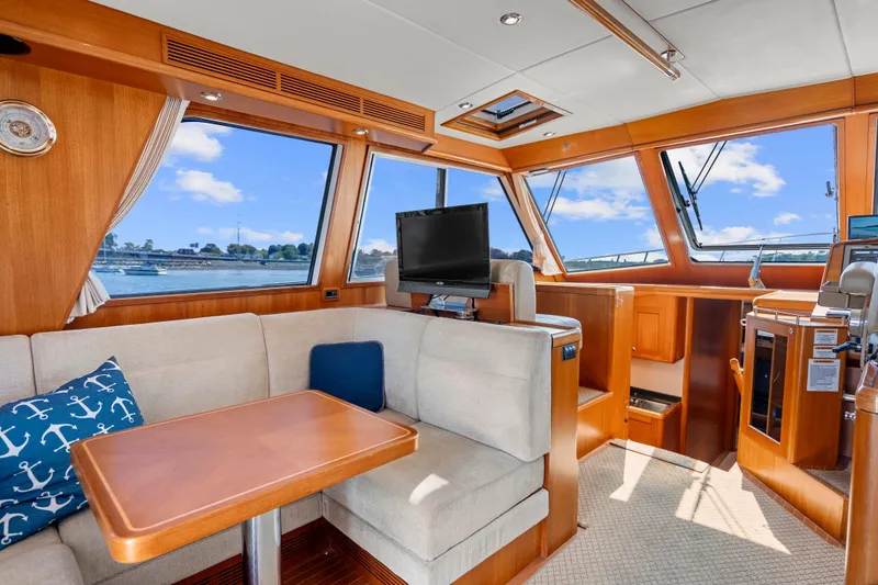 Whole Life Yacht Photos Pics Luxurious interior of 2011 Grand Banks 46 Eastbay SX yacht with plush seating and scenic windows.