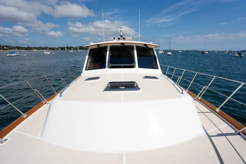 Whole Life Yacht Photos Pics 2011 Grand Banks 46 Eastbay SX yacht on calm waters under blue sky.
