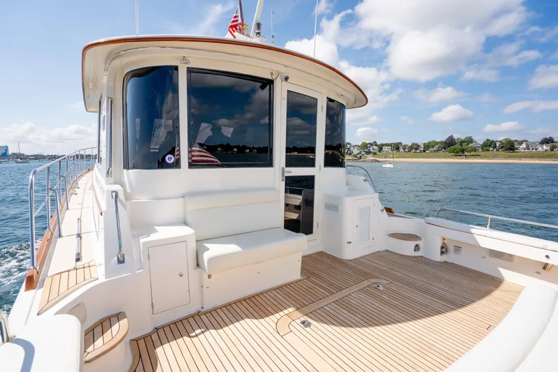 Whole Life Yacht Photos Pics 2011 Grand Banks 46 Eastbay SX yacht with spacious deck and scenic waterfront view.