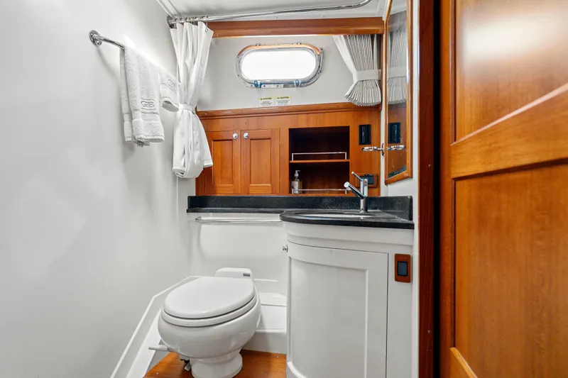 Whole Life Yacht Photos Pics Luxurious bathroom in 2011 Grand Banks 46 Eastbay SX yacht with wood accents and modern fixtures.