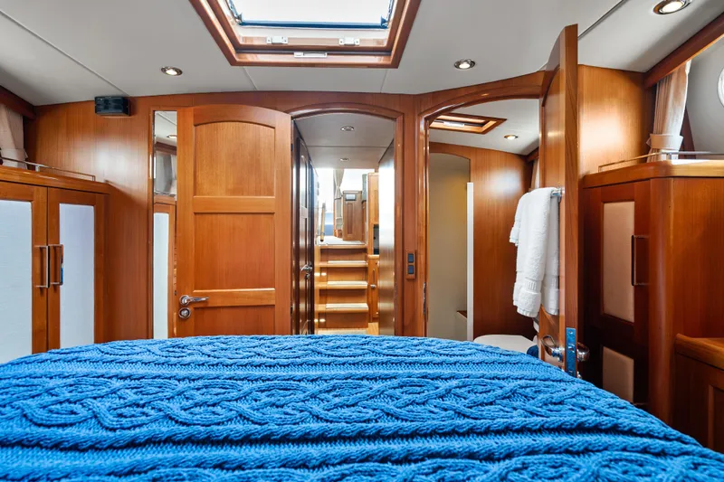Whole Life Yacht Photos Pics Luxurious 2011 Grand Banks 46 Eastbay SX yacht interior with wooden finishes and blue bedding.