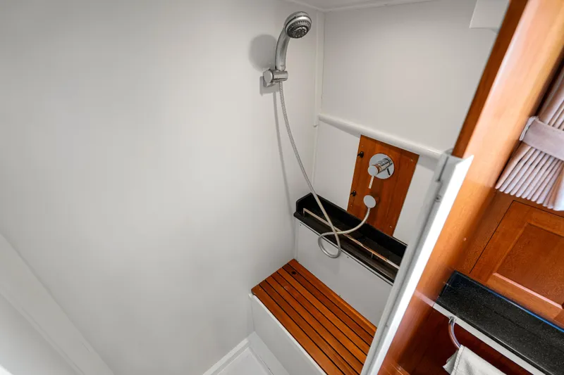 Whole Life Yacht Photos Pics Shower area in 2011 Grand Banks 46 Eastbay SX yacht with wooden bench and modern fixtures.