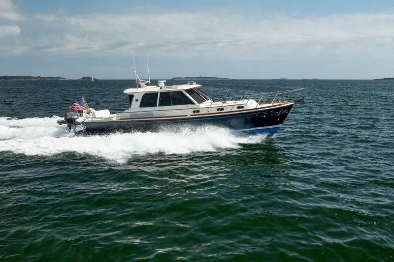 Whole Life Yacht Photos Pics 2011 Grand Banks 46 Eastbay SX cruising on open water under a clear sky.