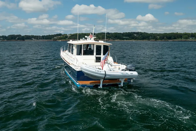 Whole Life Yacht Photos Pics 2011 Grand Banks 46 Eastbay SX yacht cruising on open water under a cloudy sky.