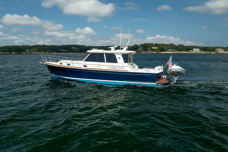 Whole Life Yacht Photos Pics 2011 Grand Banks 46 Eastbay SX yacht cruising on open water under a partly cloudy sky.