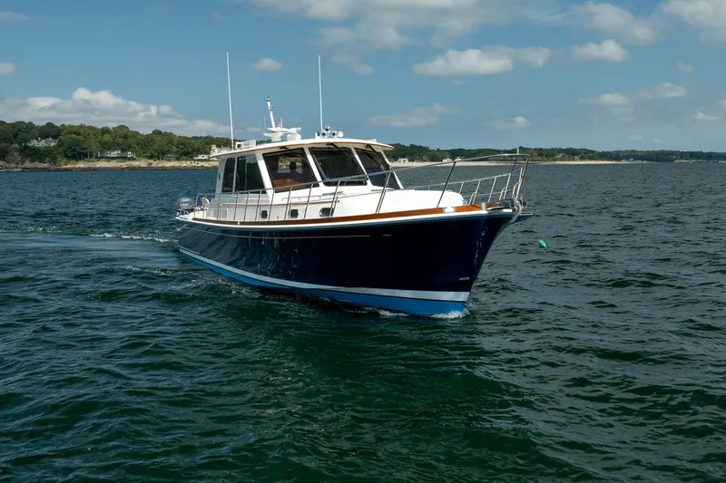 Whole Life Yacht Photos Pics 2011 Grand Banks 46 Eastbay SX cruising on open water under a clear sky.