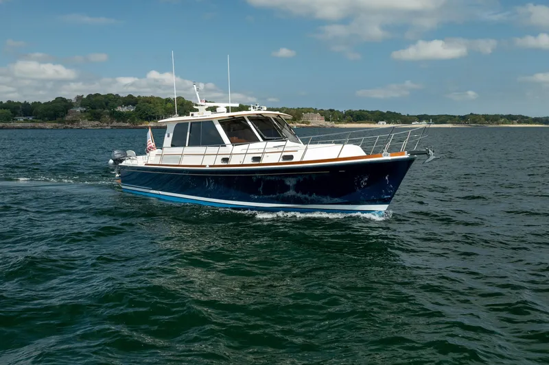 Whole Life Yacht Photos Pics 2011 Grand Banks 46 Eastbay SX cruising on open water under a clear sky.
